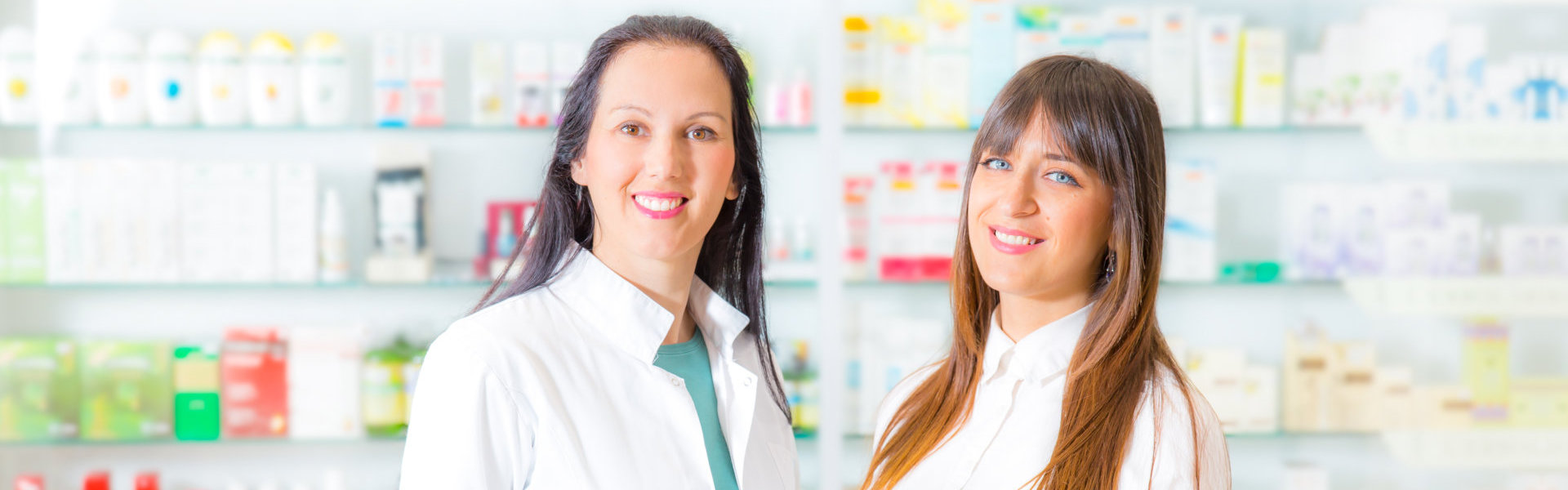 two pharmacist smiling at the camera